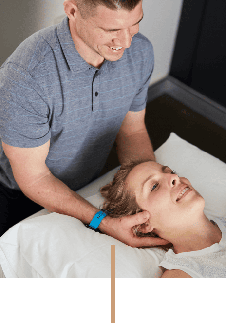 Brookvale Chiropractor Dr Glenn Stevens Helping Female Patient with Neck Pain