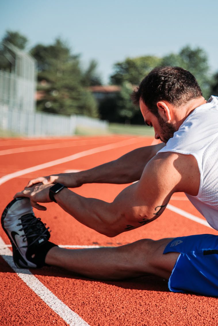 Man stretching legs to go running